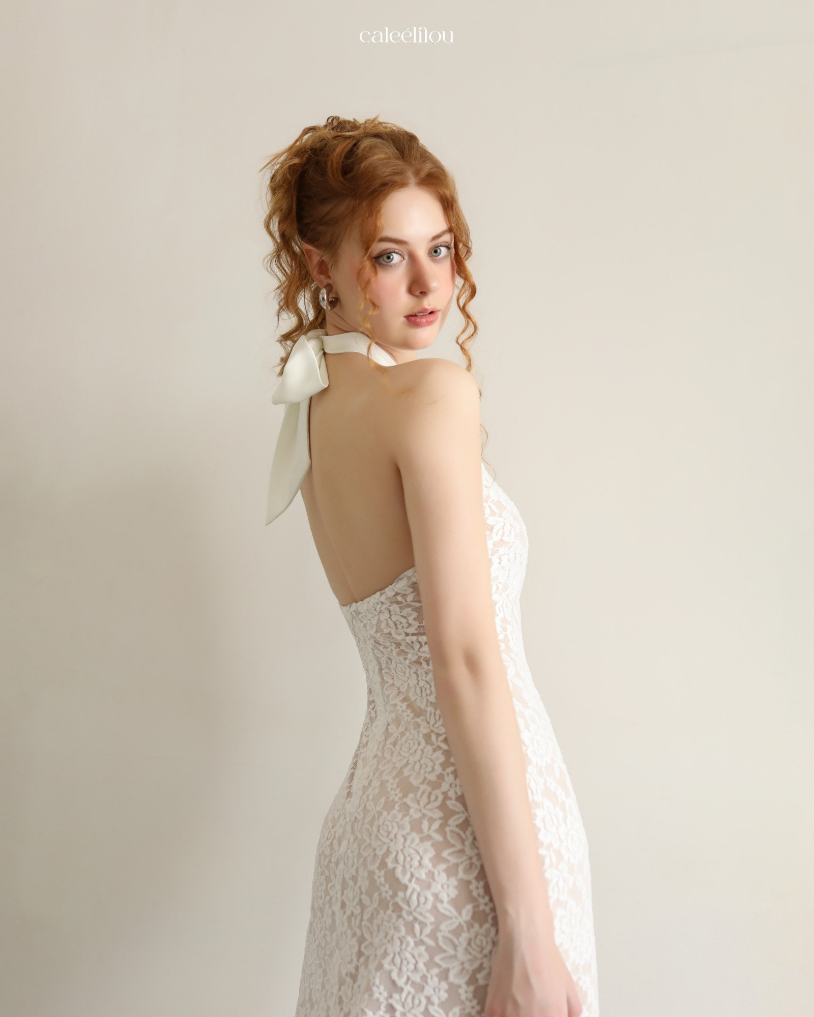 Back view of an ivory lace halter-neck dress