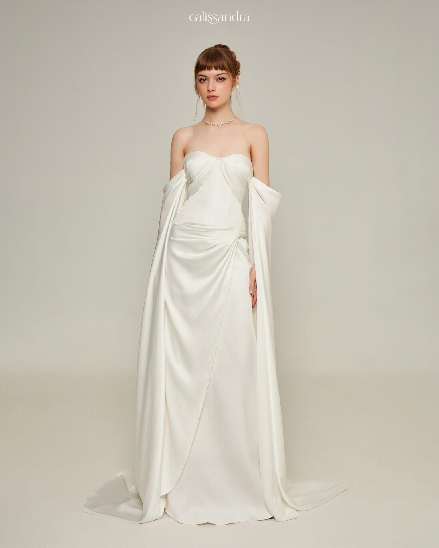 Selmira ivory bridal gown with a strapless neckline and draped skirt